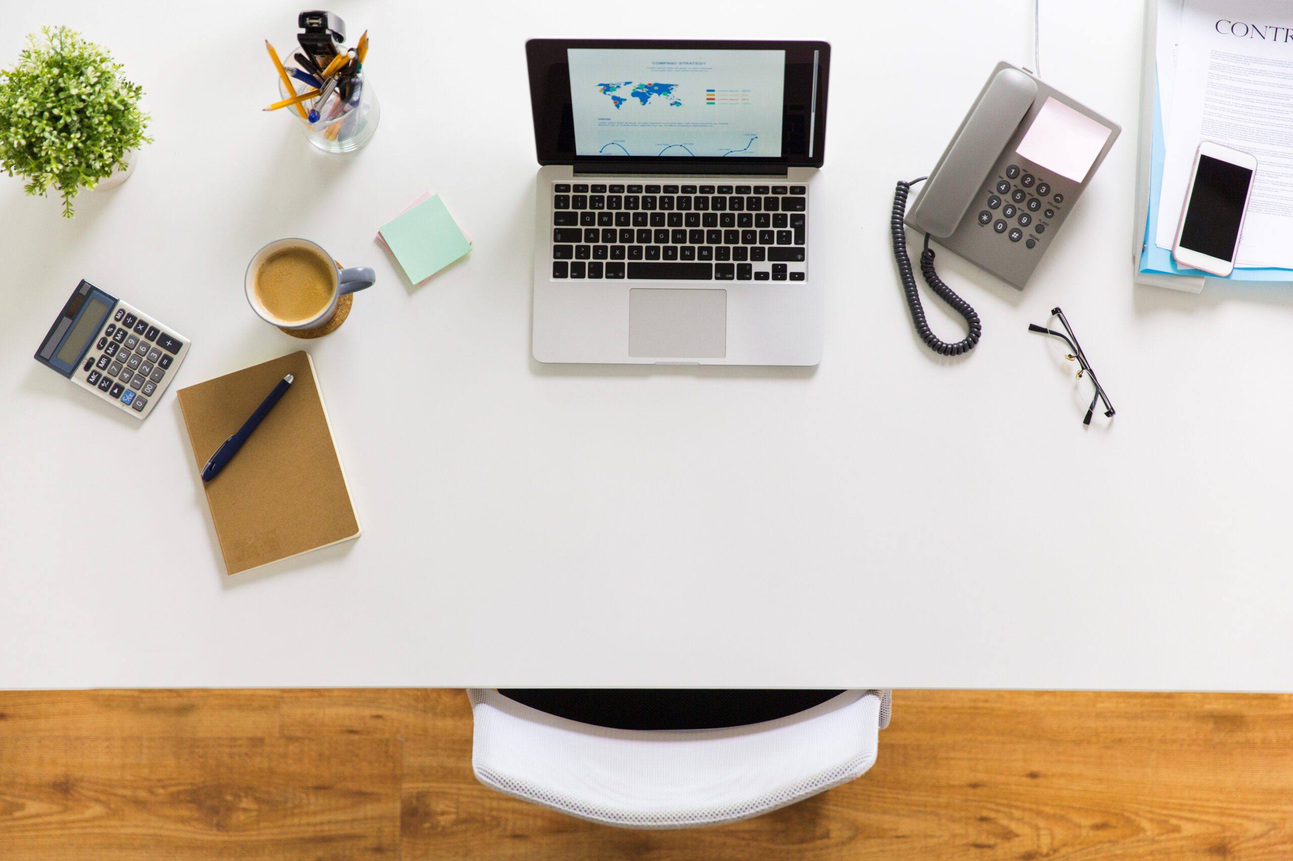 laptop, phone and other office stuff on table