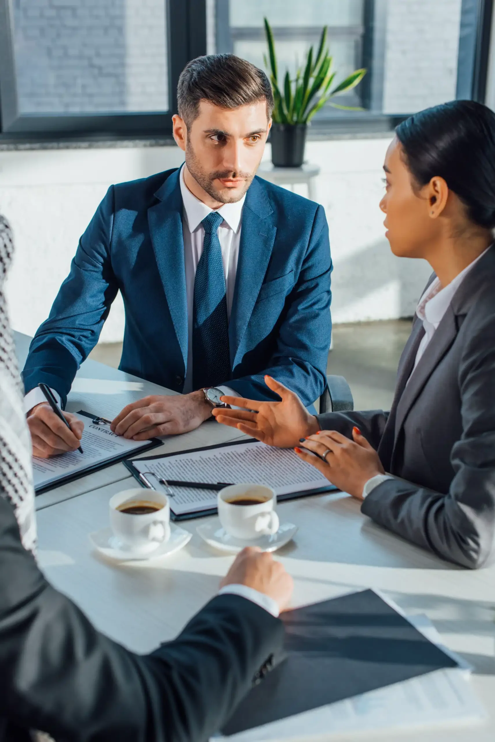 multicultural-business-partners-discussing-contrac-2024-11-09-19-31-02-utc